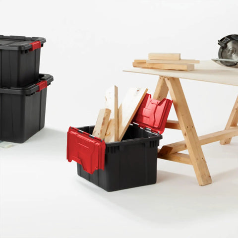 Haul Heavy Loads With Ease Using These Tough As Nails 12 Gallon Storage Totes With Secure Lids For Garage Organization Stackable Heavy Duty Crates Featuring Tie Down Grommets In A Rock Solid 12 Pack Bundle filled with wooden planks on a workbench.