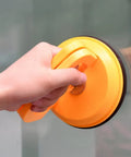 Person holding a tool from Two Pack 5 Inch Suction Cup Lifting Tool Set With 110 Lb Vertical Lift And 130 Lb Horizontal Pull For Glass Tiles