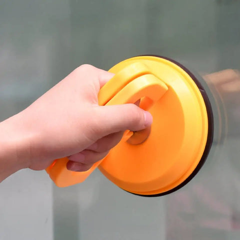 Person holding a tool from Two Pack 5 Inch Suction Cup Lifting Tool Set With 110 Lb Vertical Lift And 130 Lb Horizontal Pull For Glass Tiles