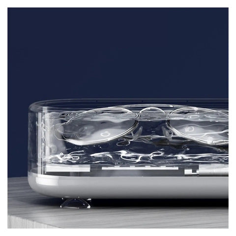 Close-up of Portable Ultrasonic Cleaner For Jewelry Eyeglasses Retainers And Watches Pink with glasses submerged in water.