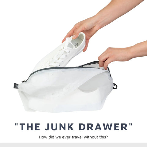 Person placing white shoe in the Large Compression Packing Cube Set With See Through Mesh For Travel Organizers, space saving luggage cubes.