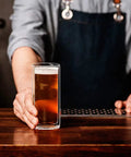 Slick Double Wall Insulated Glass Tumbler Set Featuring 16 Oz Collins Style Highball Cups holding craft beer on bar countertop.
