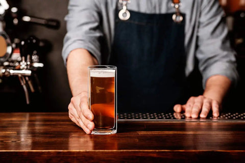 Slick Double Wall Insulated Glass Tumbler Set Featuring 16 Oz Collins Style Highball Cups holding craft beer on bar countertop.