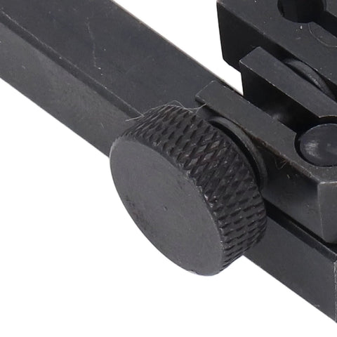 Close-up view of knurled adjustment knob on a black metal dial test indicator height holder clamp