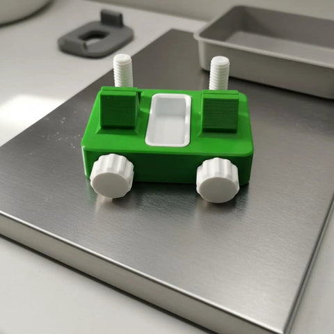 Wire Soldering Fixture with Adjustable Clamp Lightweight Electric Wire Holder in green plastic with white knobs on metal surface