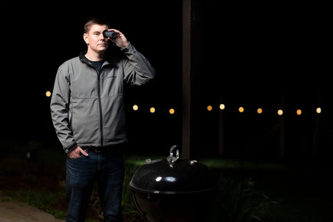 Person using Compact Infrared Thermal Monocular for Night Wildlife Viewing and Outdoor Adventures at dusk.