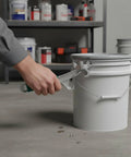 Heavy Duty Tough As Nails Multi Function Paint Pail Opener Alloy Drum Wrench opening a white paint bucket's lid.