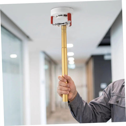Slick Aluminum Smoke Sensor Removal Tool For Ceilings Universal Fire Alarm Disassembly Grip held upwards by hand.