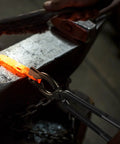 Hardcore Blacksmith Tongs Set 17 Inch Carbon Steel Forging Tongs One Piece holding hot metal on anvil