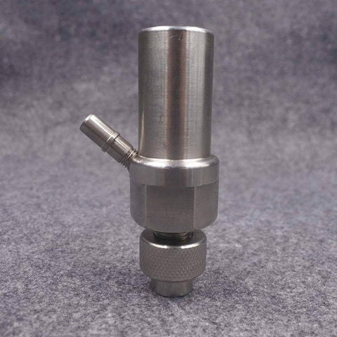 Front view of stainless steel waterjet mixing chamber and abrasive body with side inlet fitting and knurled base.