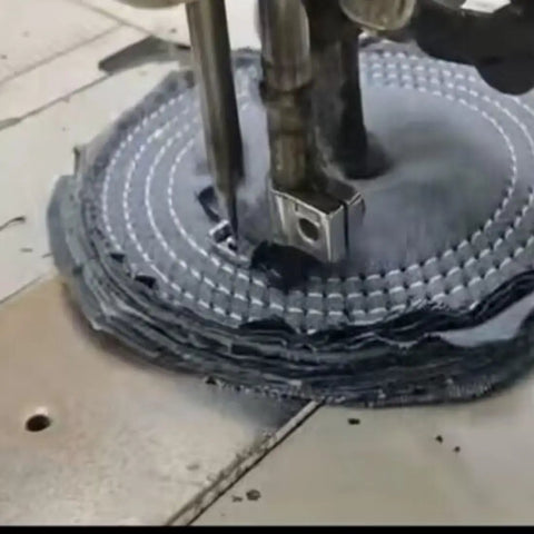 Close-up of Denim Buffing Wheel For Bench Grinder And Die Grinder, Six Inch By One Inch Thick With Half Inch Arbor being cut.