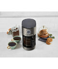 12 Cup Coffee Maker With Glass Carafe, Auto Start 24 Hour Programmable, Drip Free Pour, Black Stainless Finish on kitchen counter