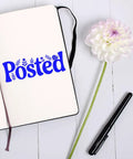 Floral 'Posted' imprint from Go To Small Duo Hand Stamp on open notebook, flower and pen nearby.