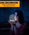 Woman holding a 3D light base, showcasing use of 12 Pack 3D Night LED Light Bases With Remote Control, ambient room decor.