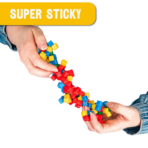 125 Pack Mini Sticky Stacking Cubes Four Color Set For STEM Hands On Building And Creative 3D Art Projects Kid Friendly Classroom And Home Decor Toy Blocks For Learning Fun. hands holding 1cm polymer cubes, super sticky