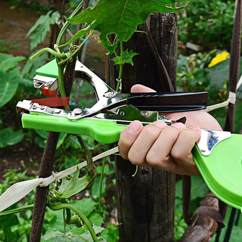 Hands using Plant Tying Gun For Grapes Raspberries Tomatoes Vining Vegetables With 10000 Staples And 20 Rolls Tape Plus Replacement Blade Upgraded Garden Tape Tool in garden
