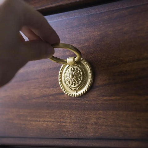 Person installing Brass Cabinet Ring Knobs Set, Gold Round European Style Drawer Pulls With Smooth Grip on wooden dresser.