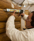 Person applying Conceal Textured Wood Caulking In Red Tone, 10.5 Ounce Tube Pack Of 12 to exterior wood surface