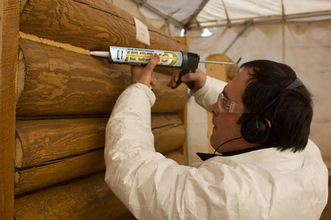 Person applying Conceal Textured Wood Caulking In Red Tone, 10.5 Ounce Tube Pack Of 12 to exterior wood surface