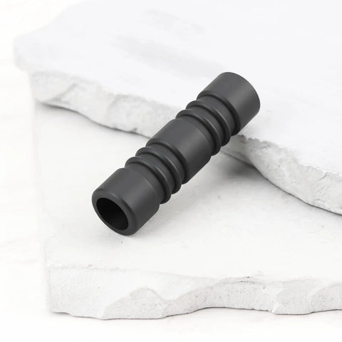 Black Anti Scald Silicone Steam Wand Sleeve 10mm 2 Pack for Most Commercial Espresso Machines, laying on stone surface.