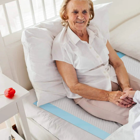 Legit Super Absorbent 23 X 36 Inch Disposable Underpads For Adults Incontinence And Seniors Straight Up Leak Proof Overnight Bed Pads Heavy Duty Pee Pads For Multi Purpose Mattress Protection 40 Count on bed with smiling elderly woman.