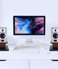 Pair Of Universal Wood Design Speaker Stands For Bookshelf Speakers And Studio Monitors, Level Up Your Home Theater Audio With 6 Inch Height In Yellow Sandalwood Finish, Stable MDF Construction For Premium Surround Sound positioned on a desk with computer setup
