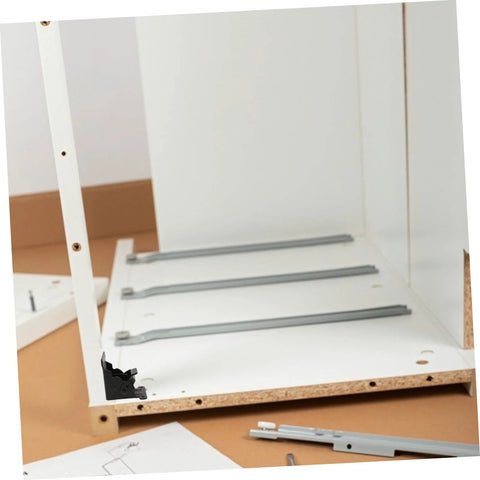 Folding table hinge replacement kit installed on partially assembled furniture, showcasing steel hinges and spring mechanism for sturdy support.