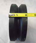Front view: Swivel caster wheel, 6x2 inch, black iron/steel with V-groove; tape measure for scale.