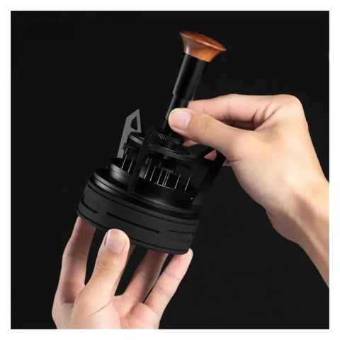 Smooth Operator Espresso Rotary WDT Tool And Coffee Stirrer With Built In Dosing Funnel Stand For Even Powder Distribution and knockout barista shots at 54mm, held in hand.