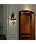 Two Light Outdoor Wall Lantern In Antique Brass Finish For Patio And Entry, classic Newbury style mounted by door, 20" high.