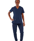 Womens Five Pocket V Neck Scrub Top For Medical Bosses Straight Fire Navy Nursing Uniform Featuring Relaxed Stretch Fabric For All Day Clinic Comfort And Fresh Style, model standing confidently in navy scrub top and pants.