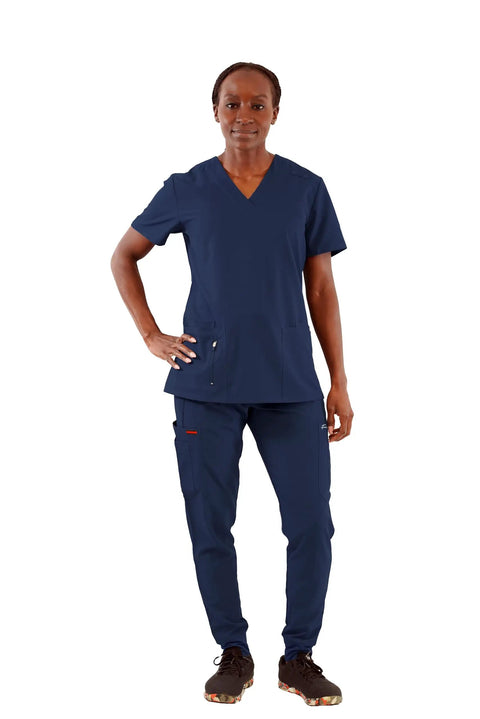 Womens Five Pocket V Neck Scrub Top For Medical Bosses Straight Fire Navy Nursing Uniform Featuring Relaxed Stretch Fabric For All Day Clinic Comfort And Fresh Style, model standing confidently in navy scrub top and pants.