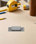 Concealed Adjustable 5 Inch Silver Door Hinge For Wooden Cabinets And Secret Bookcases, shown on a workbench surrounded by tools.