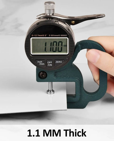Close-up of a caliper measuring 1mm thickness of Peel And Stick White Marble Vinyl Floor Tiles 12x12 Inch 1mm Thick Waterproof Self Adhesive Flooring