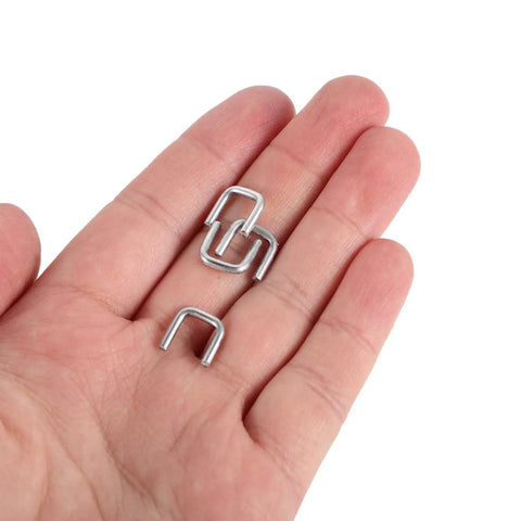 Bulk 4000 Piece Aluminum U Shaped Sausage Casing Clips And Nail Clippers For Rapid Batch Production Fast Changeover Tools held in hand.