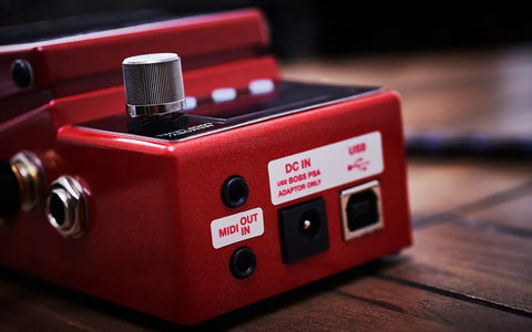 Close-up of RC-5 Loop Station High Resolution 32-Bit AD/DA and 32-Bit Float Processing Looper ports and controls on wood surface.