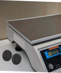 4 Pcs Grippy No Slip Rubber Feet With Threaded Base For Food Scales And Industrial Platforms, shown next to digital scale