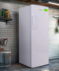Straight Up Spacious 11 Cubic Foot Upright Freezer With Built In Drawer Organizer And Easy Manual Defrost in a garage setting.