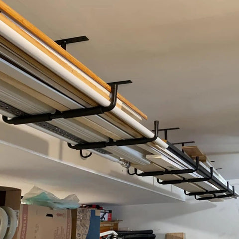 Heavy Duty Ceiling Storage Hooks For Garage Set Must Have, Overhead Rack To Hang Lumber, Ladders, Pipes, Fishing Rods, Bikes And Gear, Space Saving J Hooks, 2 Pack, Sturdy Ceiling Mounted Organizer holding lumber and materials.