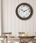 26 Inch Indoor And Outdoor Farmhouse Clock With Thermometer And Hygrometer All In One Weather Station Wall Art And Timepiece For Home Decor In Grey Oak Finish UV Resistant mounted on dining area wall.