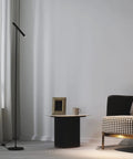 Tall LED Floor Lamp With Foot Switch 66 Inch Modern Standing Lamp next to a chair and table in a living room setup