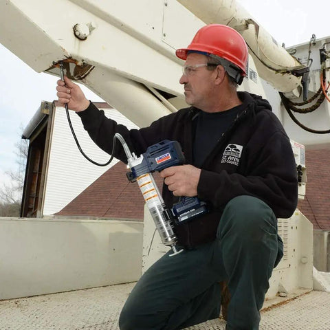 Technician using Lincoln 1884 PowerLuber 20V Battery Powered Grease Gun With 36 Inch Hose For Automotive, Agricultural And Industrial Equipment, 10,000 PSI.