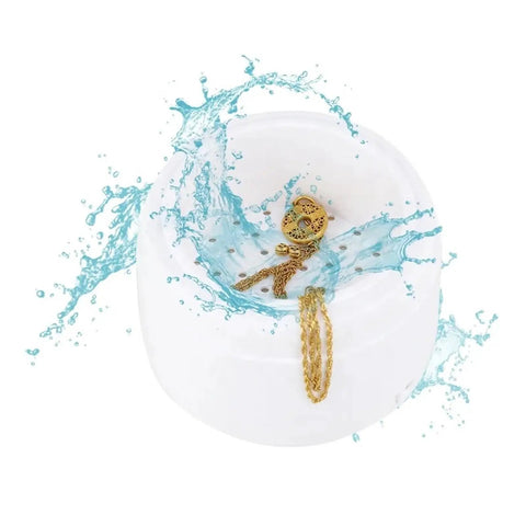 Premium Portable Ultrasonic Cleaner For Jewelry And Watches Compact Design with gold jewelry and water splash inside.