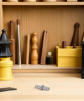 Heavy Duty Stainless Steel Spring Hinge Pins For Cabinet Doors and Wardrobe Drawers on a wooden workbench with tools.
