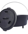 Black cast iron Dutch oven with lid and handle, featuring sturdy design and three legs, perfect for outdoor cooking and camping.