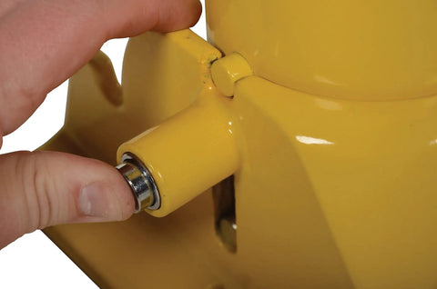 Lockable Steel Fold Down Bollard Parking Barrier Rock Solid Safety Post with hand engaging the lock mechanism.