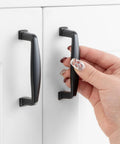 Black Zinc Alloy Cabinet Pull Handle With 3 Inch Hole Centers Stepped Design installed on white cabinet door