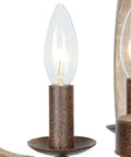 Close-up of bulb and rustic bronze arm on 4 Light Farmhouse Chandelier With Handmade Wood Frame And Rustic Bronze Arms