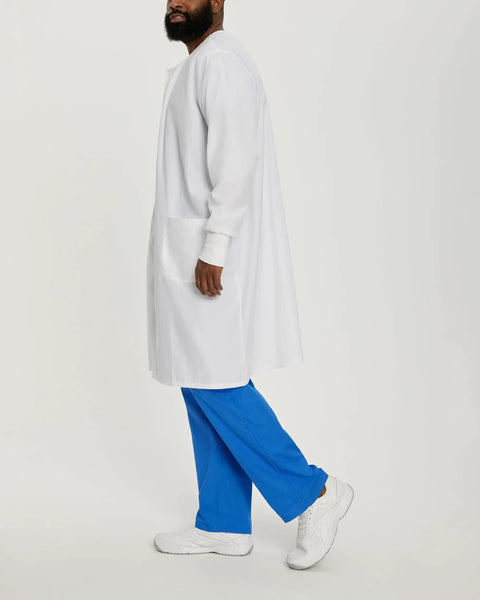 Side view of Relaxed Fit Unisex Full-Length Lab Coat With Snap Front And Two Spacious Pockets, model wearing blue pants