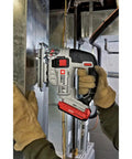 Close-up of Shop Tested 20V Max Cordless Jigsaw, held in gloved hand, cutting through metal, showcasing easy swap blade clamp feature.